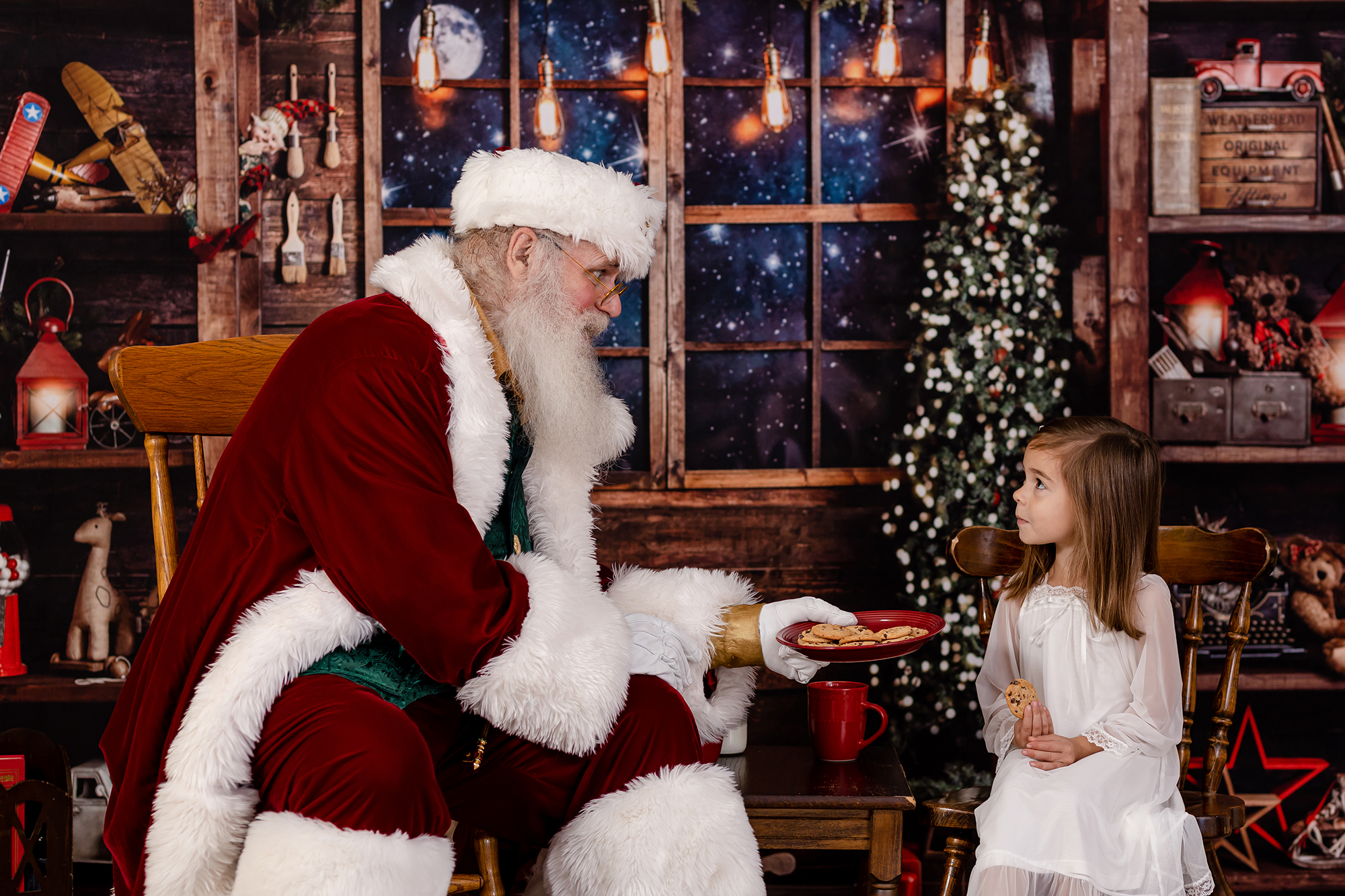girl with santa eating cookies