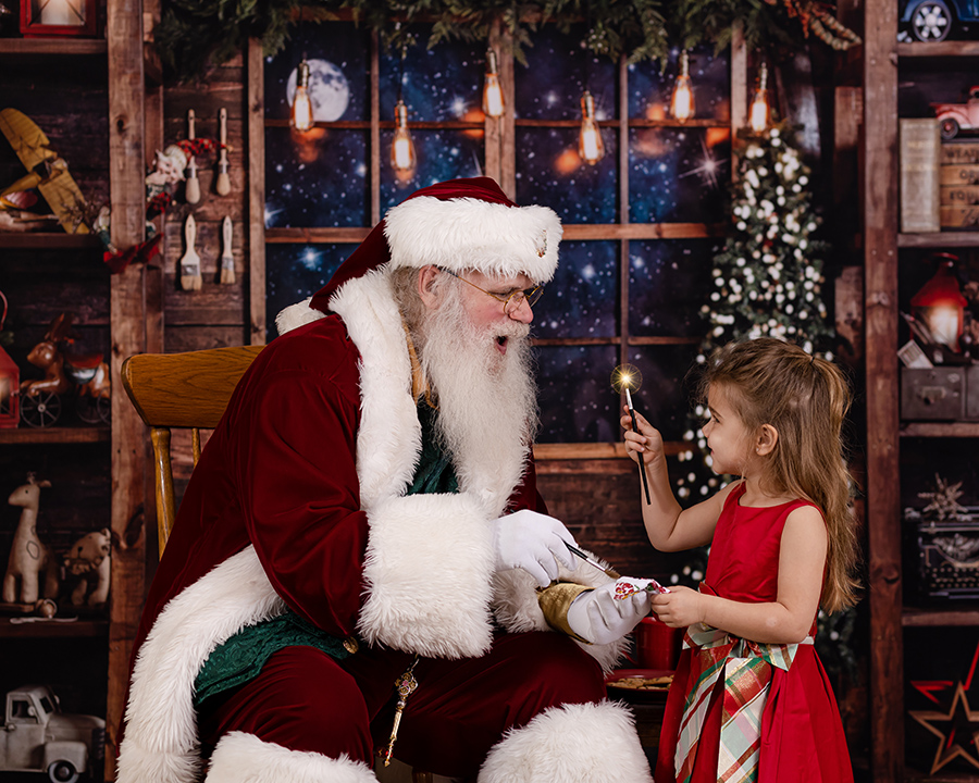 girl paiting magic with santa