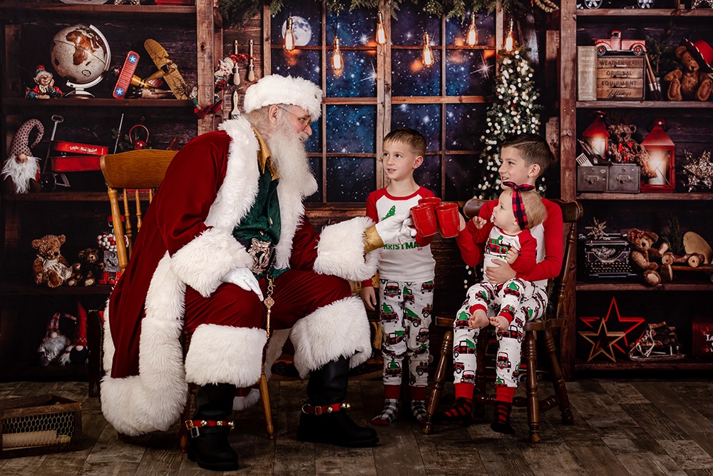 little girl pointing to the nice list with Santa Claus